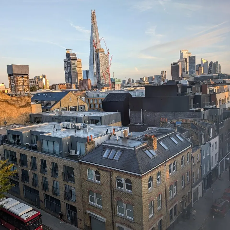 London rooftops at golden hour with the Shard in the distance