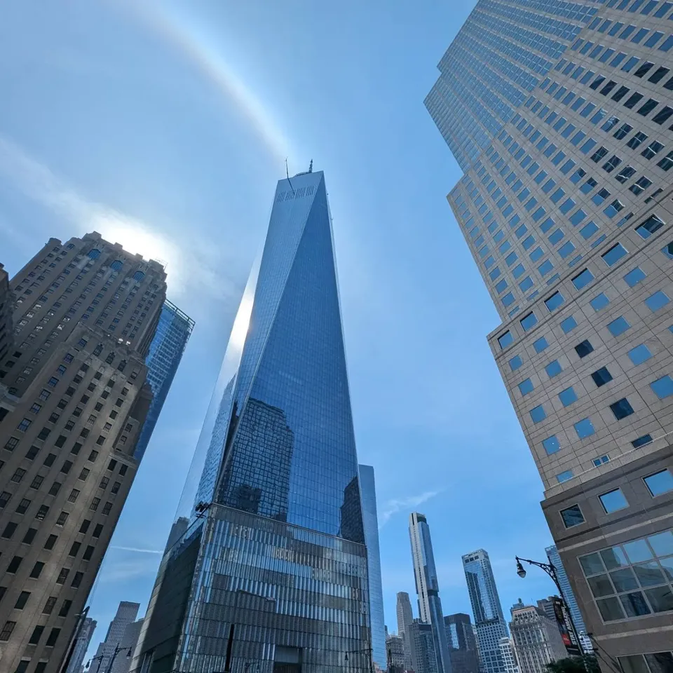 Looking up at One World Trade Center between neighbouring towers