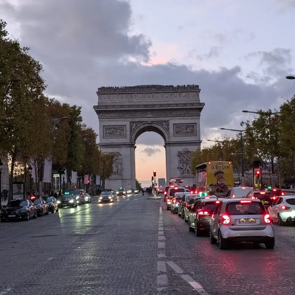 The Arc de Triomphe at the end of a tree-lined avenue